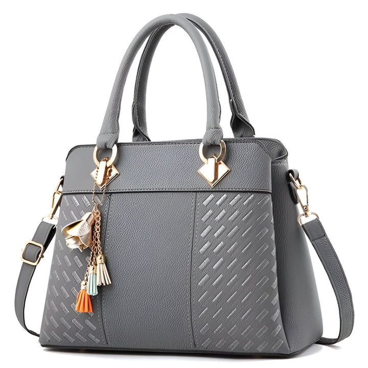 Sac à main gris avec motif texturé, anses, bandoulière et charm doré à pompons., 46193874075872,46193874108640,46193874141408,46193874174176,46193874206944,46193874239712