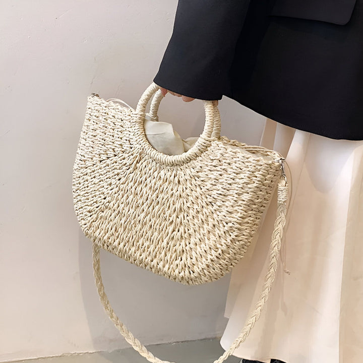 Sac en paille beige porté avec anses rondes et bandoulière., 46194029854944,46194029887712