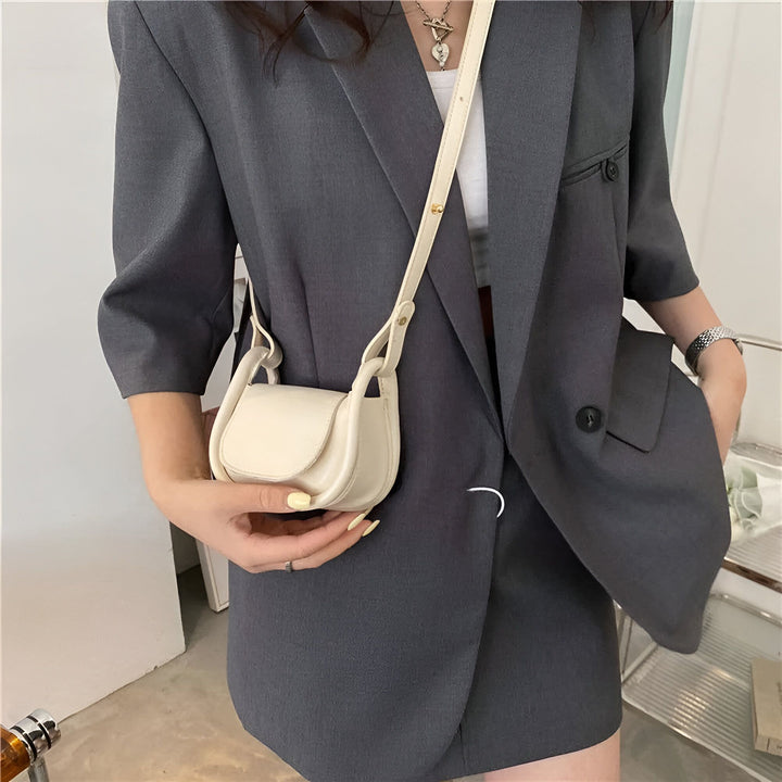 Sac à main blanc porté par une femme en blazer gris, 46193971232992,46193971265760,46193971298528,46193971364064,46193971396832
