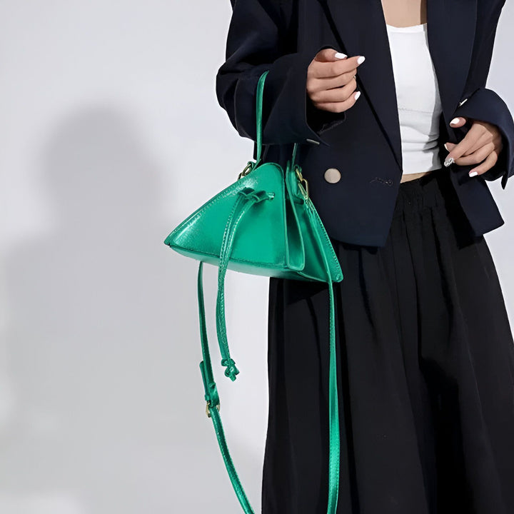 Femme tenant un sac à main vert brillant triangulaire., 46194018320608,46194018353376,46194018386144,46194018418912,46194018451680,46194018484448