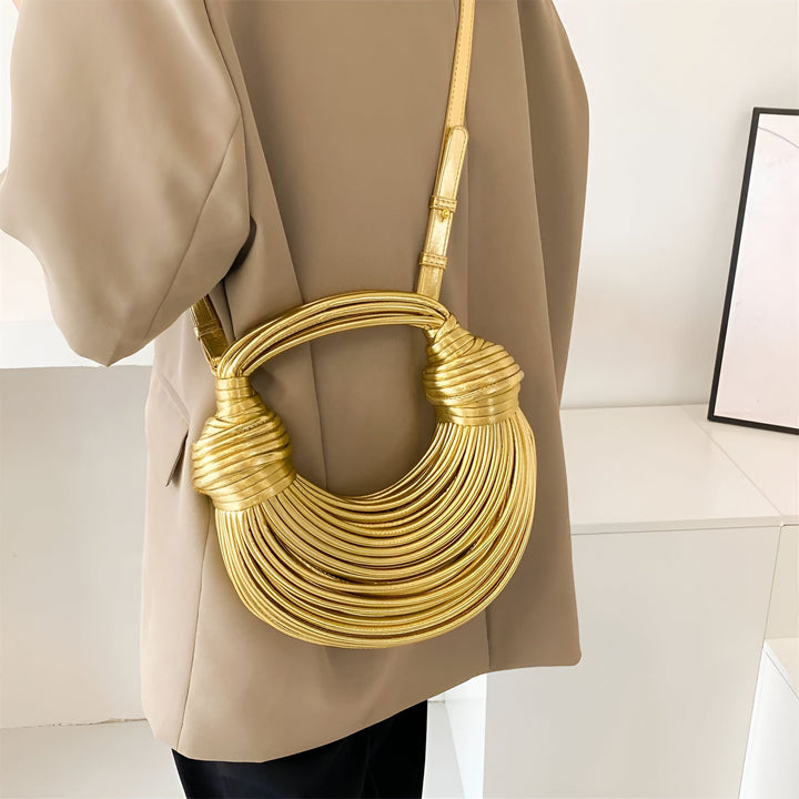 Sac à main doré texturé porté avec blazer beige, 46194034737376