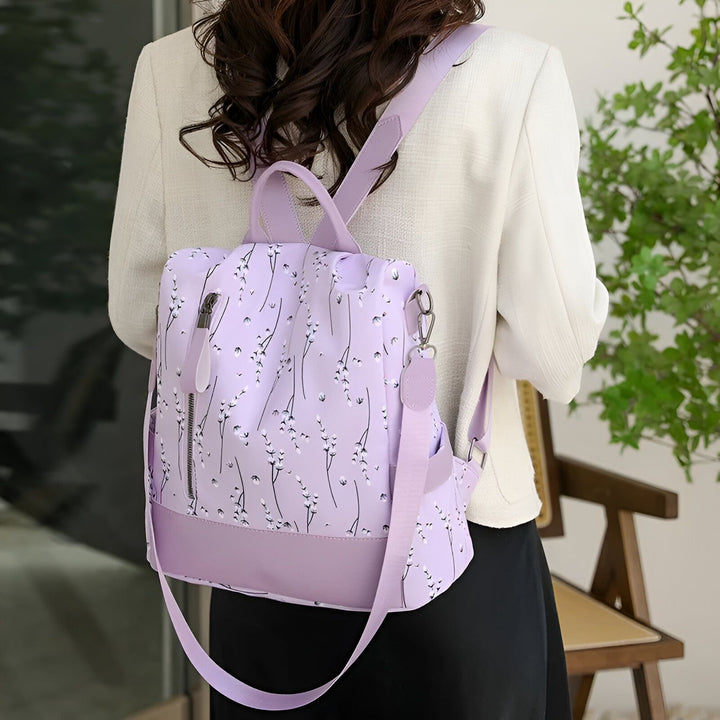 Sac à dos lilas à motif de fleurs blanches, porté par une femme, 46193997971680,46193998004448,46193998037216,46193998069984