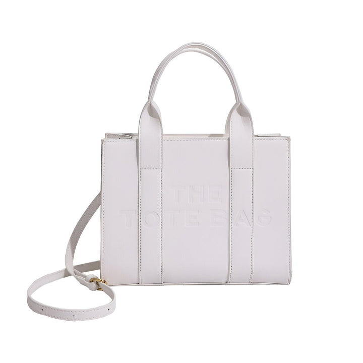 Sac tote bag blanc avec texte "THE TOTE BAG" embossé, poignées et bandoulière amovible., 46193877811424,46193877844192,46193877876960,46193877909728,46193877942496,46193877975264,46193878008032,46193878040800