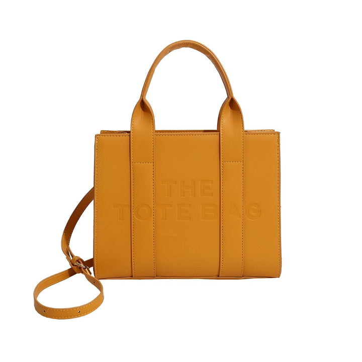 Sac cabas jaune moutarde avec anses et bandoulière amovible, texte THE TOTE BAG embossé sur le devant., 46193877811424,46193877844192,46193877876960,46193877909728,46193877942496,46193877975264,46193878008032,46193878040800