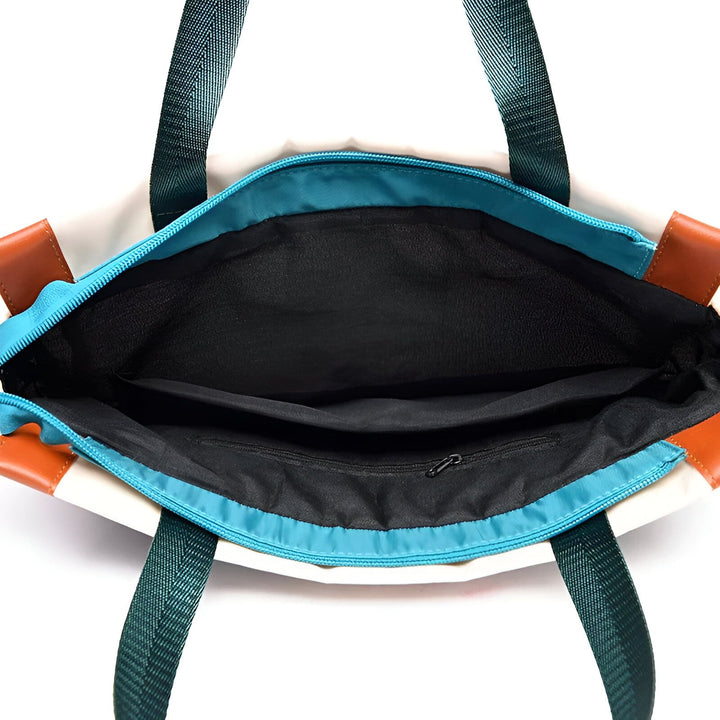 Intérieur ouvert d'un sac fourre-tout noir avec fermeture éclair bleue et poche zippée., 46193874665696,46193874698464,46193874731232,46193874764000