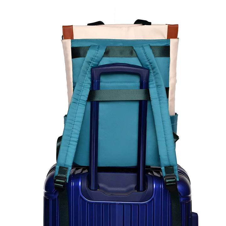 Vue arrière d'un sac à dos de voyage bleu posé sur une valise bleue avec sangle pour bagage., 46193874665696,46193874698464,46193874731232,46193874764000