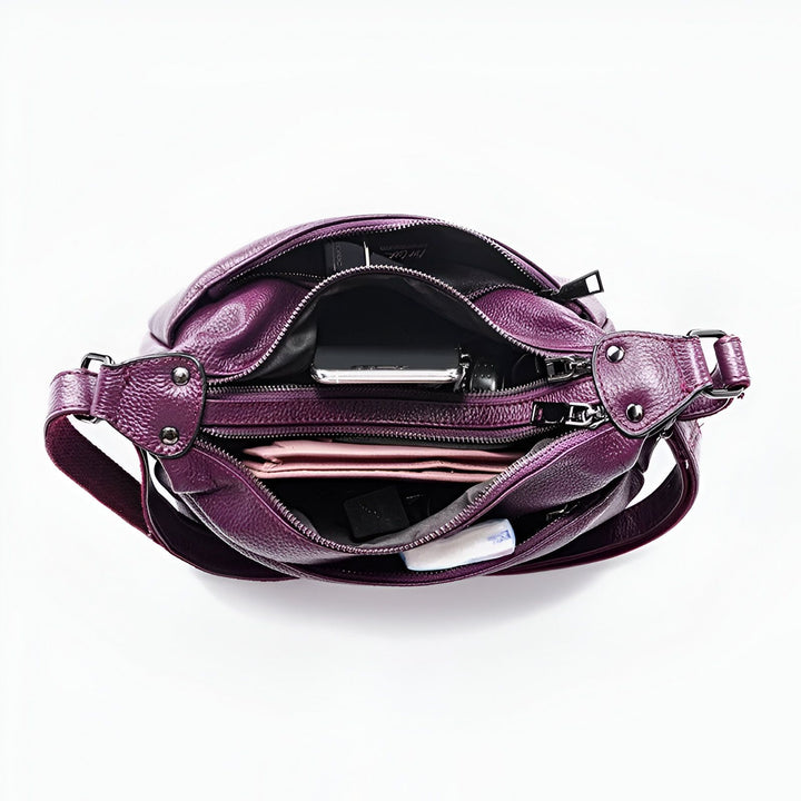 Sac à main violet en cuir ouvert avec téléphone et portefeuille à l'intérieur., 46193842487520,46193842520288,46193842553056,46193842585824