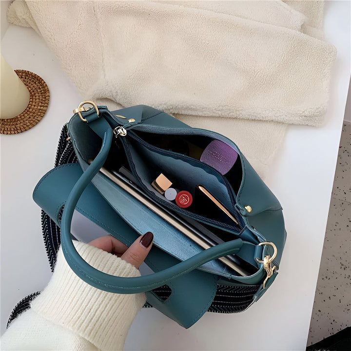 Vue du dessus d'un sac à main turquoise ouvert, tenu par une main en pull crème., 46193884102880,46193884135648,46193884168416,46193884201184