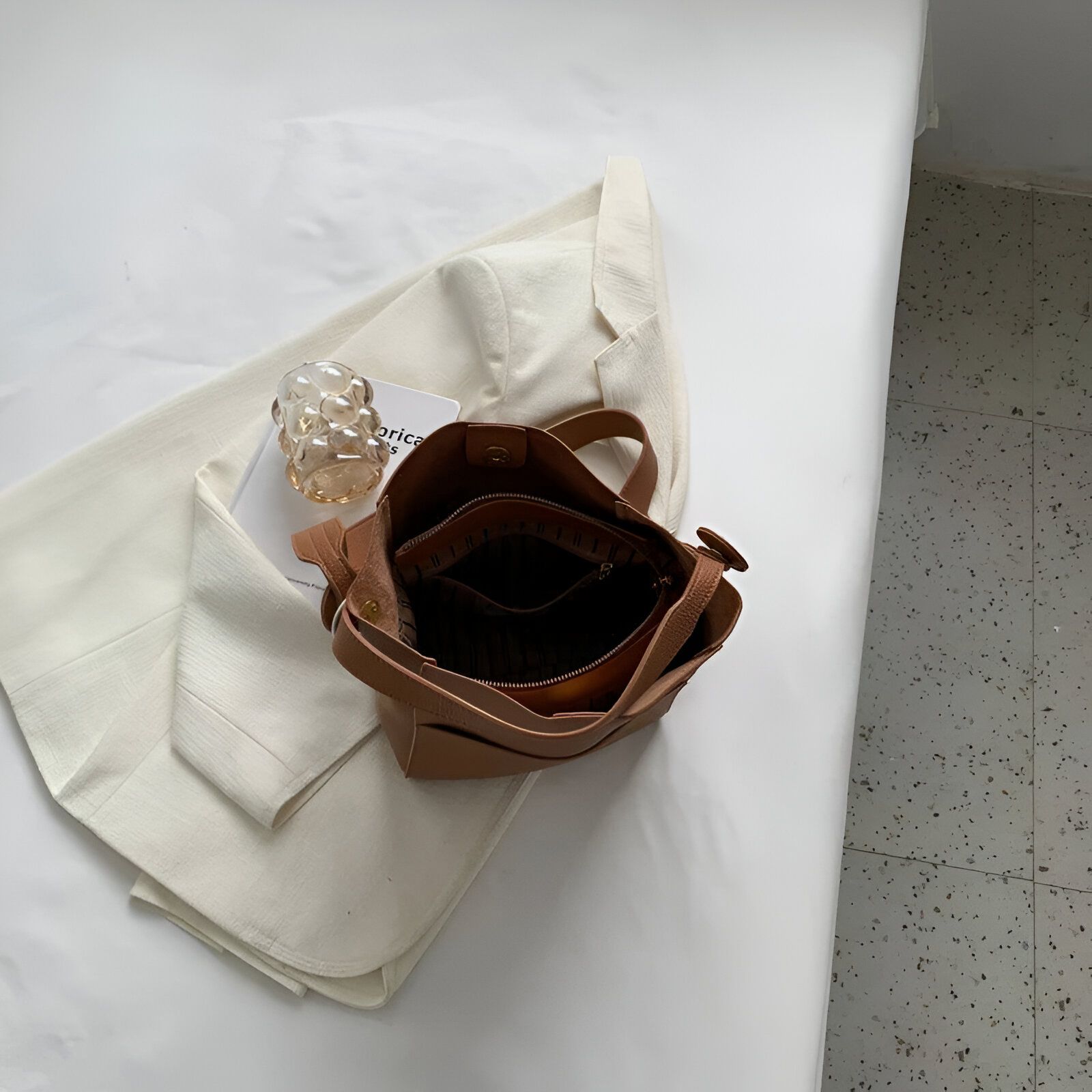 Un sac à main en cuir marron foncé ouvert, montrant l'intérieur.