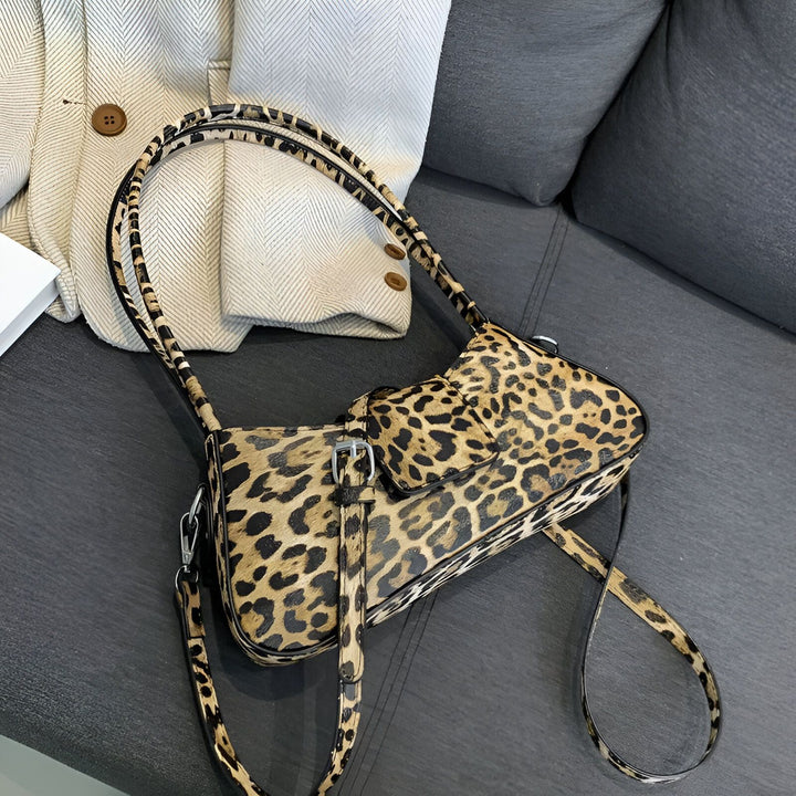 Sac à main imprimé léopard posé sur un canapé gris., 46193944035552,46193944068320,46193944101088