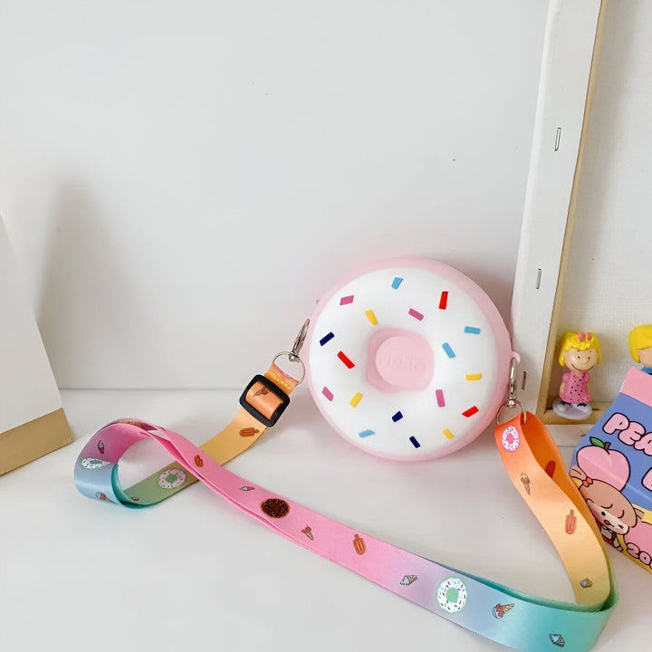 Sac en forme de donut rose avec paillettes colorées et sangle arc-en-ciel décorée de friandises., 46193978802400,46193978835168,46193978867936,46193978900704