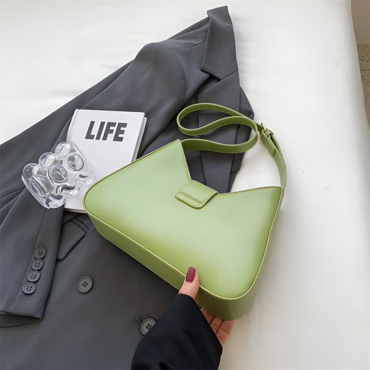 Sac à main vert clair en forme de triangle avec anse, posé sur veste grise., 46193872797920,46193872830688,46193872863456,46193872896224