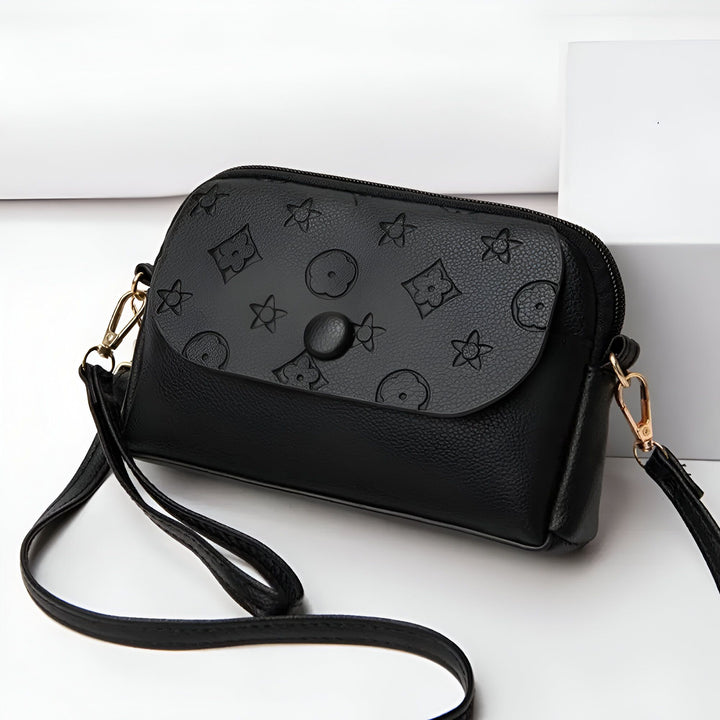 Sac à bandoulière noir avec rabat à motif étoile et fleur, fermeture bouton et zip, détails dorés., 46262992503008,46262992535776,46262992568544,46262992601312,46262992634080,46262992666848,46262992699616